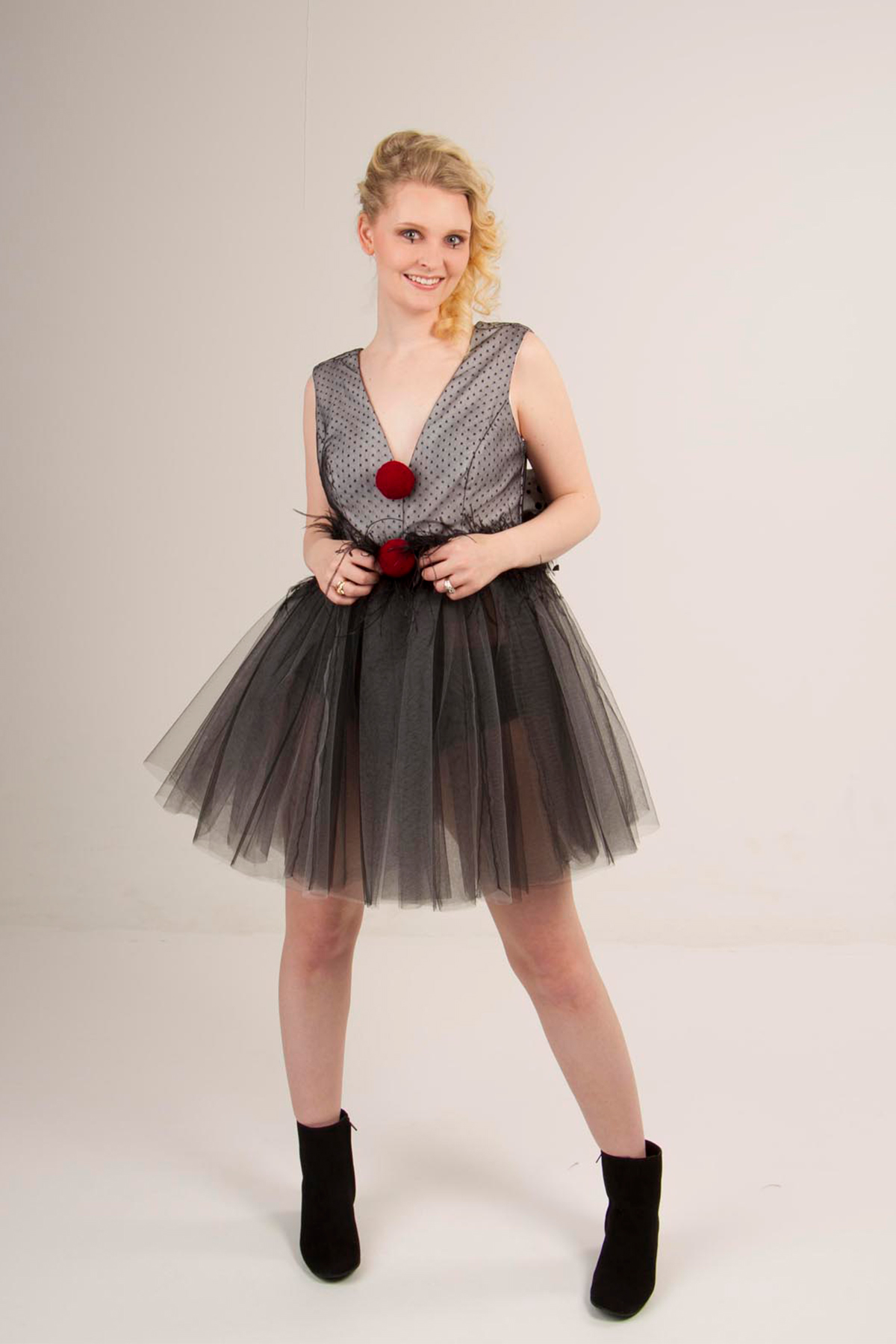Dress bodice with polka dot overlay, full tulle skirt with an ostrich feather
                trim and pompoms.