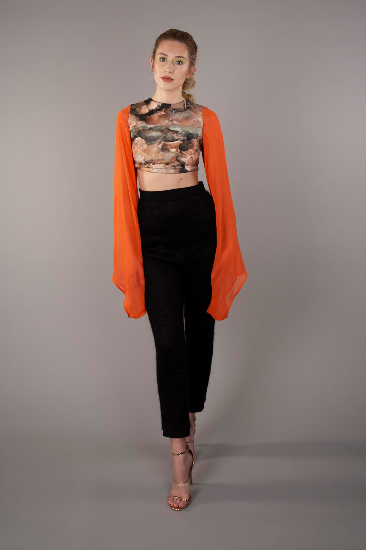 Black high-waisted mohair fitted pants paired with a cotton sateen printed crop and chiffon exaggerated sleeves
